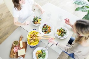 women eating and discussing intuitive eating