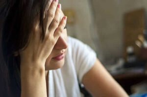 Woman rests head as she considers a depression treatment program