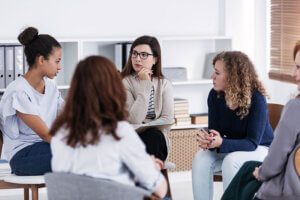 Women talk and bond during a life skills training program